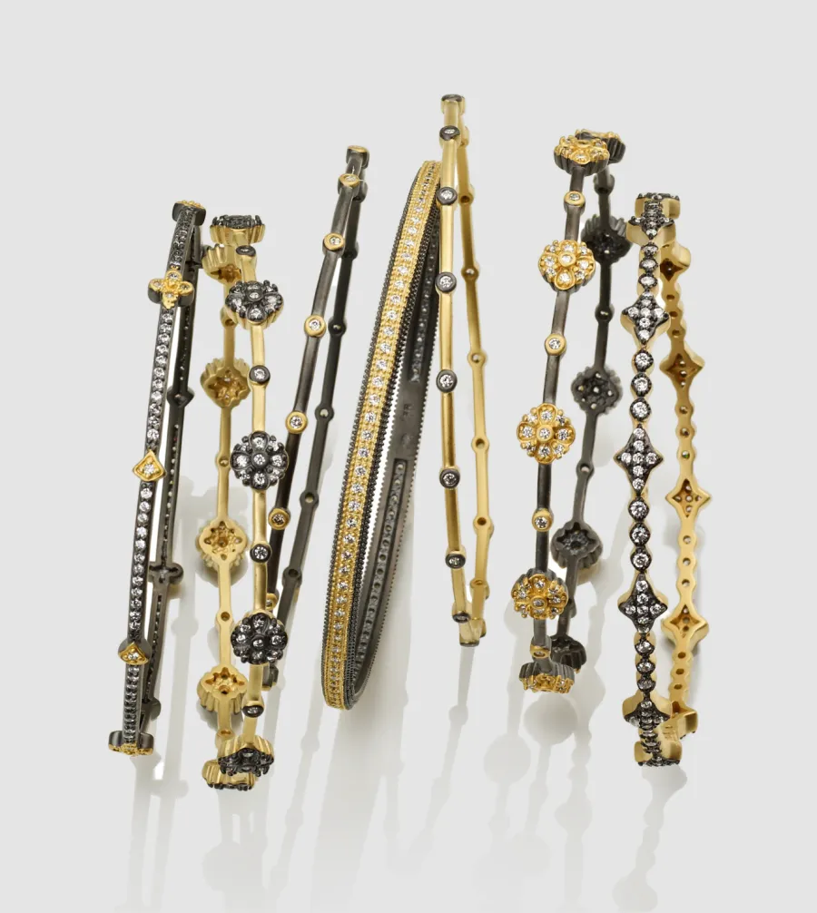 Mixed gold and black bracelet stack, directed product photography