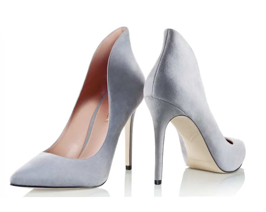 Gray pointed-toe heels on black background, directed product photography